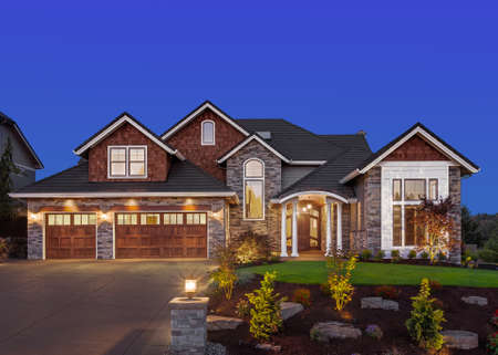 Front exterior of luxury home in evening Front exterior of luxury home in evening