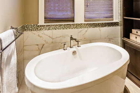 White bathtub in luxury master bathroom in new homeの写真素材