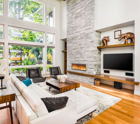 living room interior with hardwood floors and fireplace in new luxury homeの写真素材
