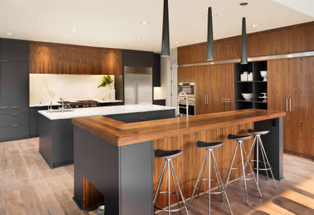 Kitchen Interior with Two Islands, Two Sinks, Cabinets, and Hardwood Floors in New Luxury Home Kitchen Interior with Two Islands, Two Sinks, Cabinets, and Hardwood Floors in New Luxury Home