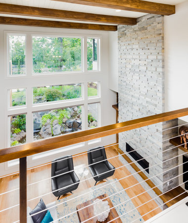 living room interior with hardwood floors and view of lush vegetation