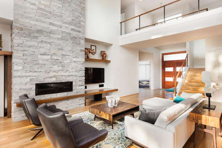 Beautiful living room with hardwood floors and fireplace in new luxury homeの写真素材