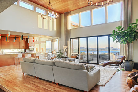 Living room with vaulted ceilings, hardwood floors, and view in new luxury home
