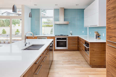 Contemporary style kitchen in new luxury home, with stainless steel appliances, hardwood floors, and sleek linesの写真素材