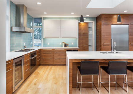 Contemporary style kitchen in new luxury home, with stainless steel appliances, hardwood floors, and sleek linesの写真素材