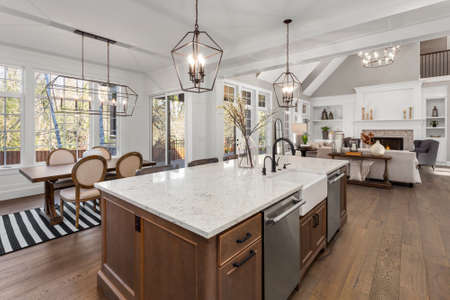 Beautiful kitchen in new traditional style luxury home, with quartz counters, hardwood floors, and stainless steel appliancesの写真素材