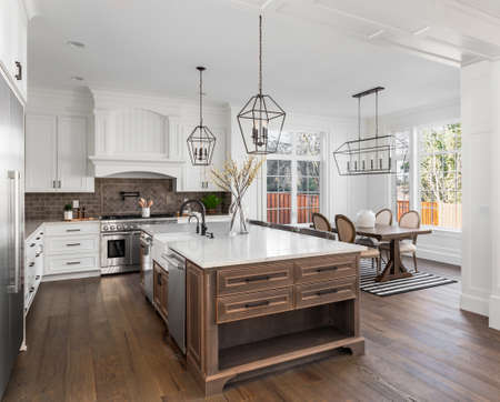 Beautiful kitchen in new traditional style luxury home, with quartz counters, hardwood floors, and stainless steel appliancesの写真素材