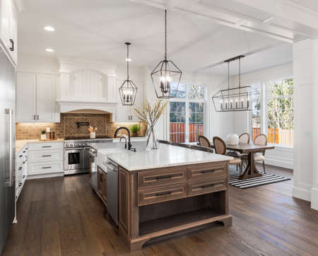 Beautiful kitchen in new traditional style luxury home, with quartz counters, hardwood floors, and stainless steel appliancesの写真素材