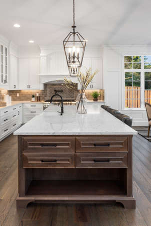 Beautiful kitchen in new traditional style luxury home, with quartz counters, hardwood floors, and stainless steel appliancesの写真素材