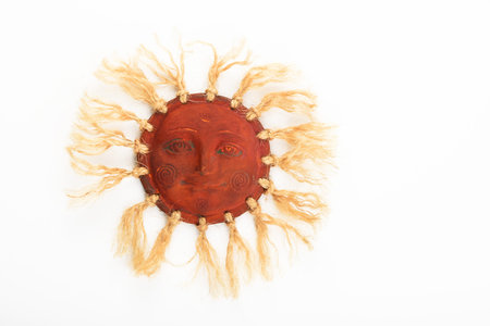 Mexican traditional ceramic happy sun face symbol plate with rays of jute rope isolated on whiteの写真素材