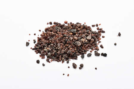 Handful of Indian brown salt isolated on white backgroundの写真素材