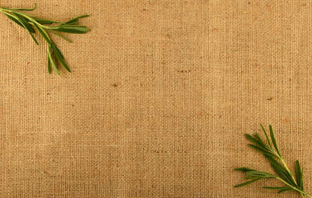 Jute canvas with rosemary leaves in corners, add your textの写真素材
