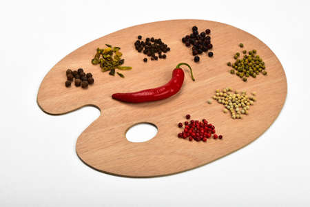 Palette of spices, collection of various spices on wooden palette isolated on whiteの写真素材