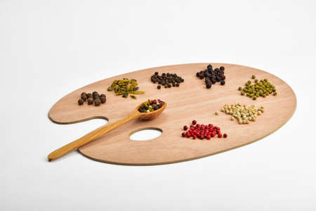 Palette of spices, collection of various spices on wooden palette isolated on whiteの写真素材