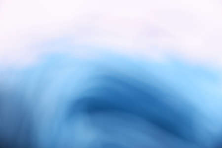 Abstract light blue and white cloudy wave and spiral blur backgroundの写真素材