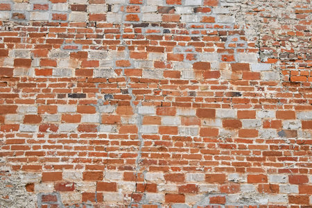 Antique wall texture of red and white bricks of different sizes
