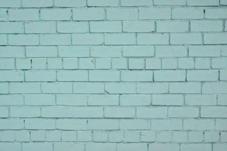 Blue teal painted pale old brick wall texture backgroundの写真素材