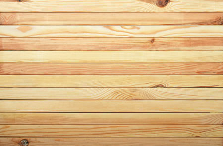 Horizontal unpainted raw light pine wooden narrow planks panel texture backgroundの写真素材