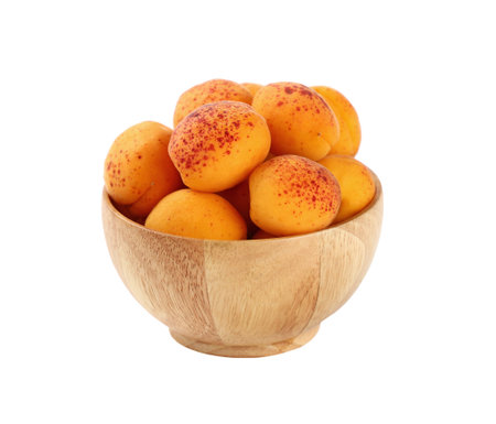 Mellow ripe fresh apricots with in small wooden bowl isolated on white background, close upの写真素材