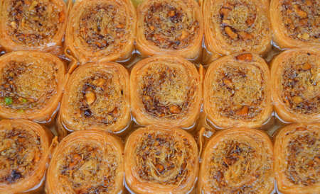 Baklava, traditional oriental sweet round pastry cookies with nuts in retail market display, close up, high angle viewの写真素材