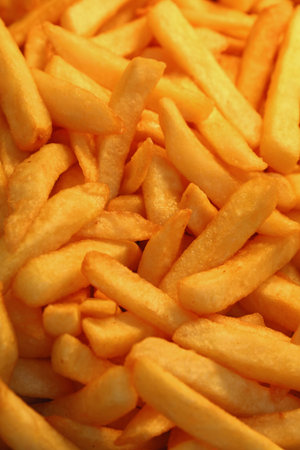 French fries, unhealthy deep fried potato chips close up, high angle view