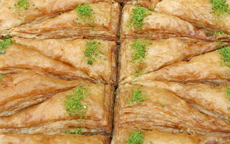 Baklava, traditional oriental sweet pastry cookies with pistachio in retail market display, close up, high angle viewの写真素材