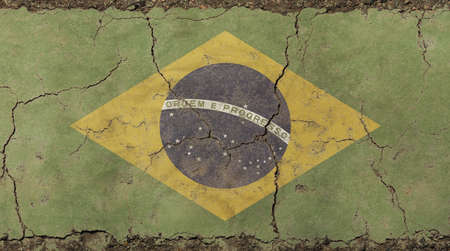 Old grunge vintage dirty faded shabby distressed Federative Republic of Brazil flag background on broken concrete wall with cracksの写真素材