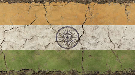 Old grunge vintage dirty faded shabby distressed Republic of India heraldic flag background on broken concrete wall with cracksの写真素材