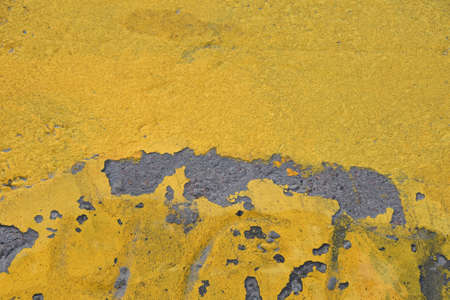 Vivid yellow painted rough concrete wall or floor texture backgroundの写真素材
