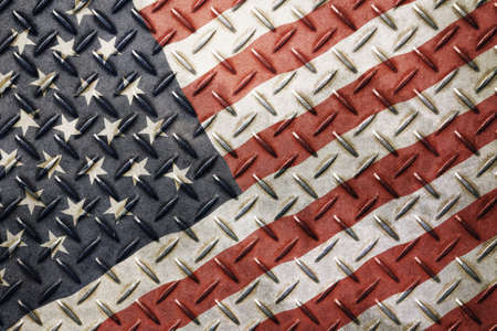 Old grunge vintage wavy American US national flag background on anti slip embossed metal steel plate textureの写真素材