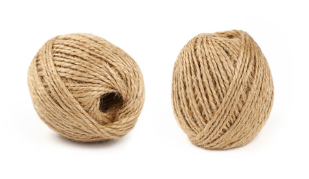 Two small coil bobbin of natural brown twine hessian burlap jute rope over white background
