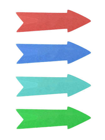 Four multicolor painted wooden direction arrows, red, blue, teal and green, isolated on white background, close upの写真素材