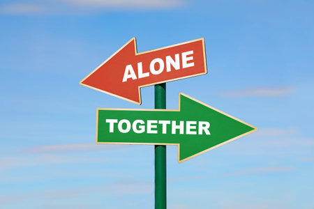 Road signpost with two arrows, green and red, with alone and together words, directing to different...