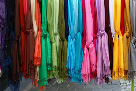 Close up selection of assorted colorful soft knitted scarves in apparel retail store display, low angle viewの写真素材