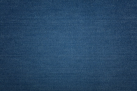 Dark indigo blue washed cotton jeans denim texture background, close upの写真素材