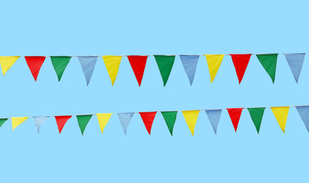 Close up many triangle multicolor red, green, blue and yellow festive colorful textile flags hanging...