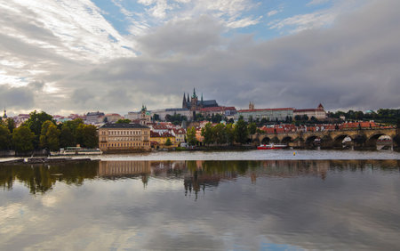High angle panorama view of Prague old town, Charles Bridge, Royal castle and Saint Vitus Cathedral over Vltava river and cloudy sky sunny dayの写真素材