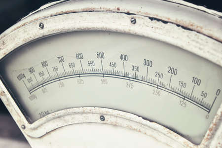 Old white antique vintage gauge weight scales close up, high angle viewの写真素材