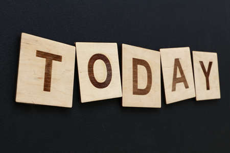 Close up word TODAY on wooden text 
letter signs over black board backgroundの写真素材