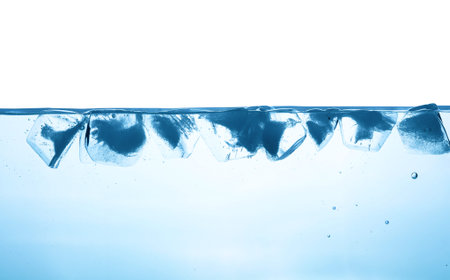 Close up water surface with ice cubes isolated on white background, low angle underwater view