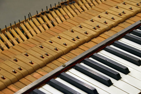 Close up tuning open old vintage piano keyboard, high angle view