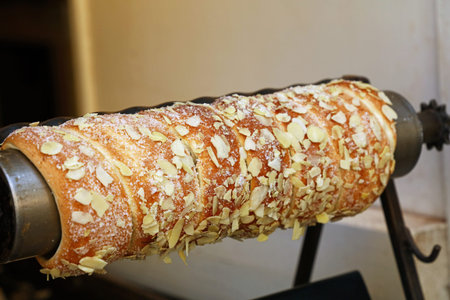 Close up retail display with ready to eat sweet Trdelnik, this spit cake is popular in Europe,...