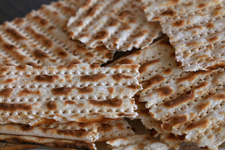 Close up square pieces of matzo flatbread crackers, traditional Jewish crispbread