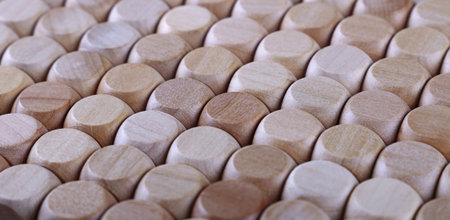 Close up background pattern of natural wooden dice shaped toy building blocks, high angle view...