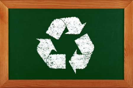 Green school chalkboard blackboard with chalk drawing of recycling logo icon in brown wooden frame
