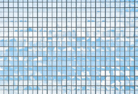 Background texture of modern business skyscraper building glass windows pattern reflecting blue sky,...