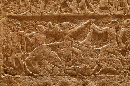 Close up background of antique stone wall with carved ancient Egyptian bas relief, front view