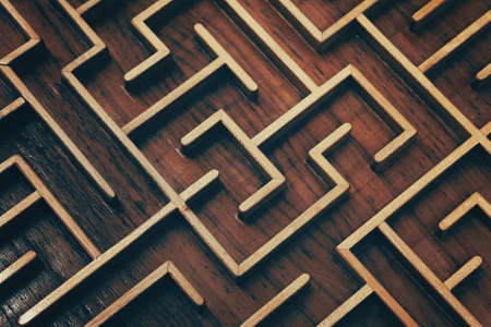 Close up of dark brown wooden labyrinth maze, toy puzzle game, elevated high angle viewの写真素材