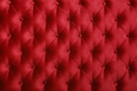 Maroon red velvet capitone textile background, retro Chesterfield style checkered soft tufted fabric...