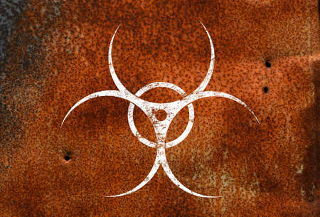 White biohazard warning sign painted over grunge red rusty corroded metal wall background with copy spaceの写真素材